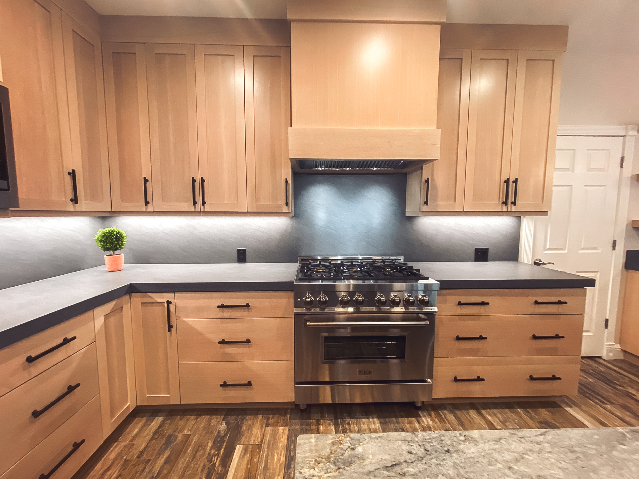Close-up of modern kitchen cabinets with clean lines, new countertops, and sleek hardware.